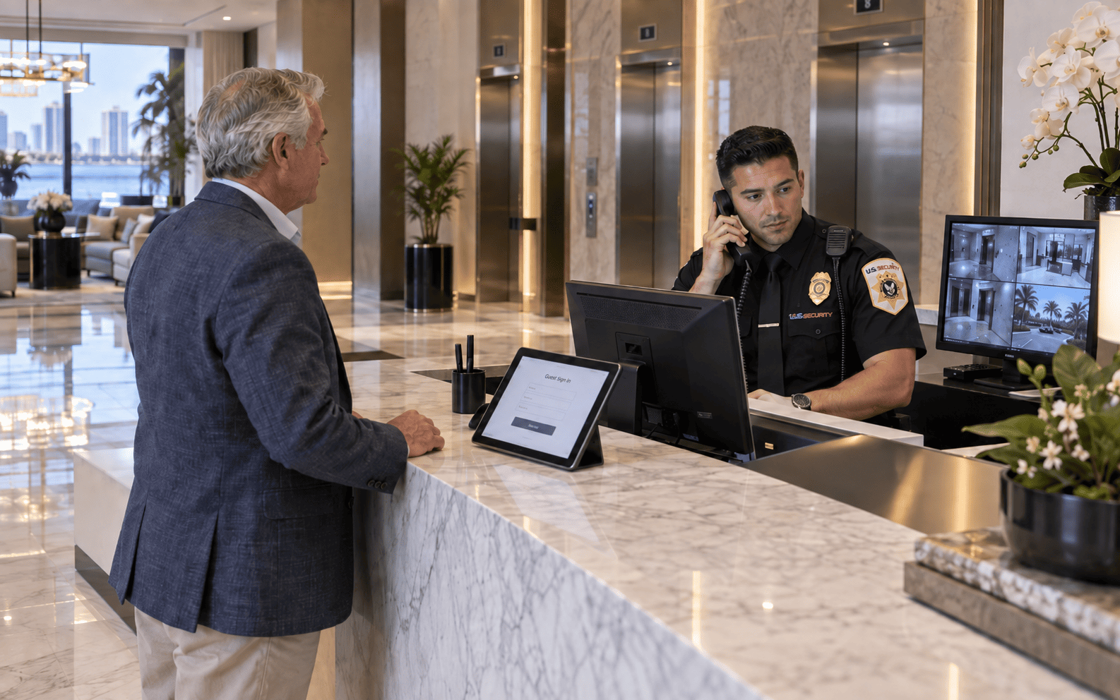 US Security concierge monitoring lobby and front desk security systems